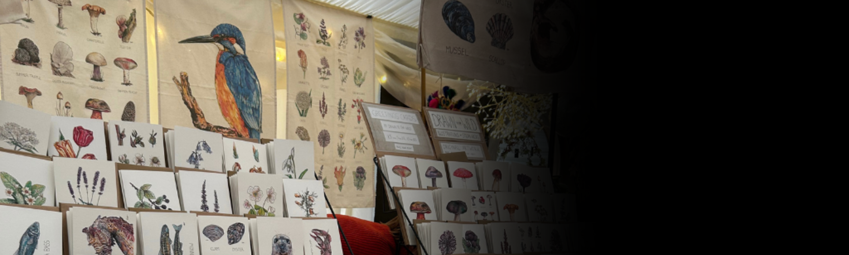 Christmas Fair stalls selling printed cards featuring animals and plants