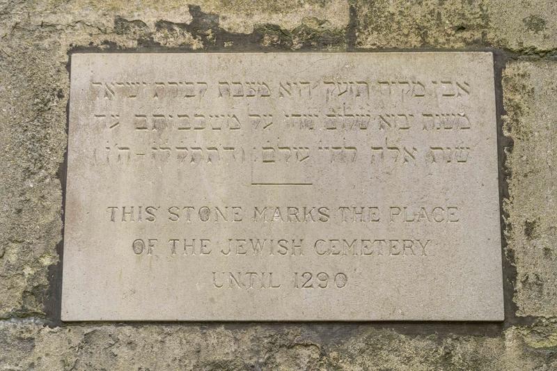 Stone laid to mark the Jewish cemetery. There is Hebrew script above, in English, below, it reads: This stone marks the place of the Jewish cemetery until 1290.